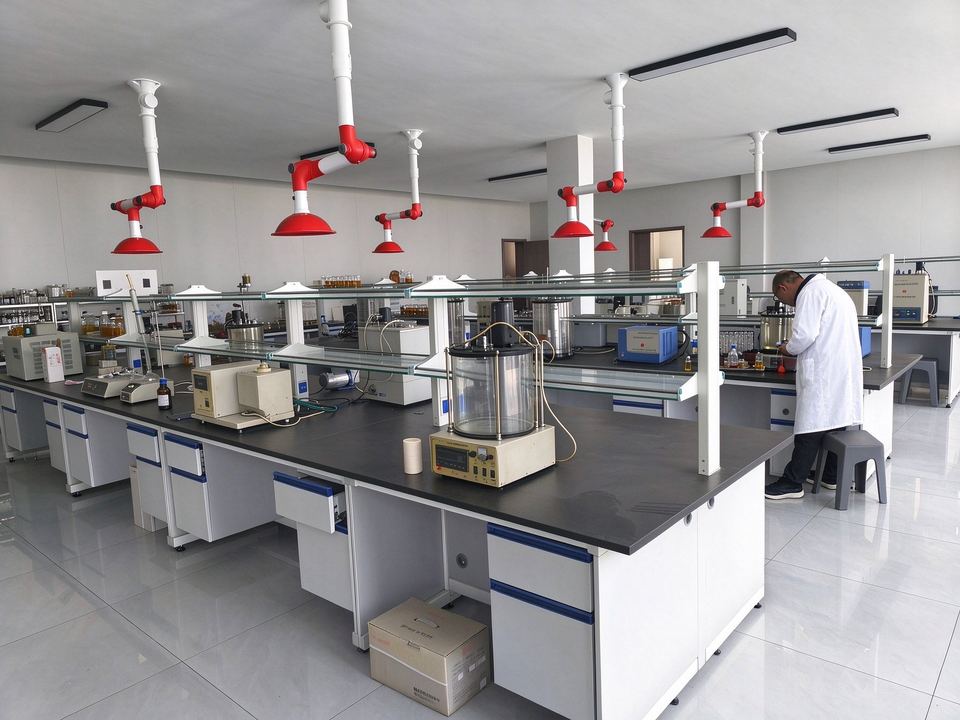 Technician running a batch-release test in the plant laboratory