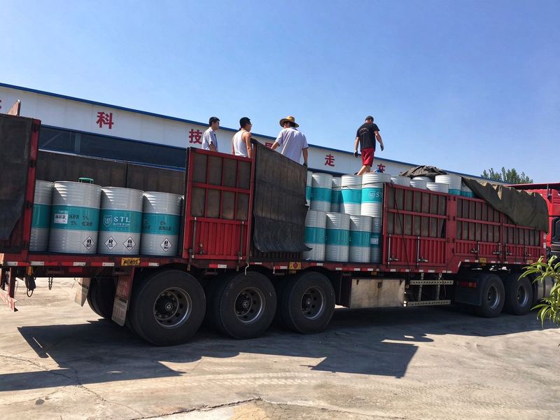 20 L pails of metalworking fluid concentrate loaded for dispatch, dilution table and hazard marks facing out